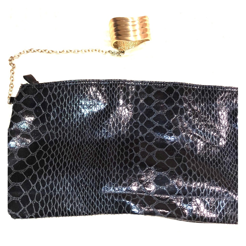 Black snakeskin clutch with gold bracelet. 👜